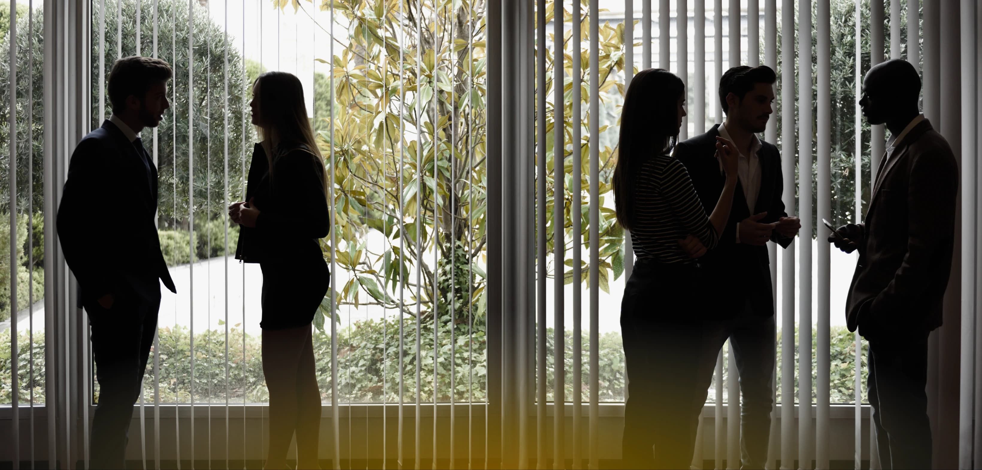 Mid-market team meeting in a glass-walled modern office