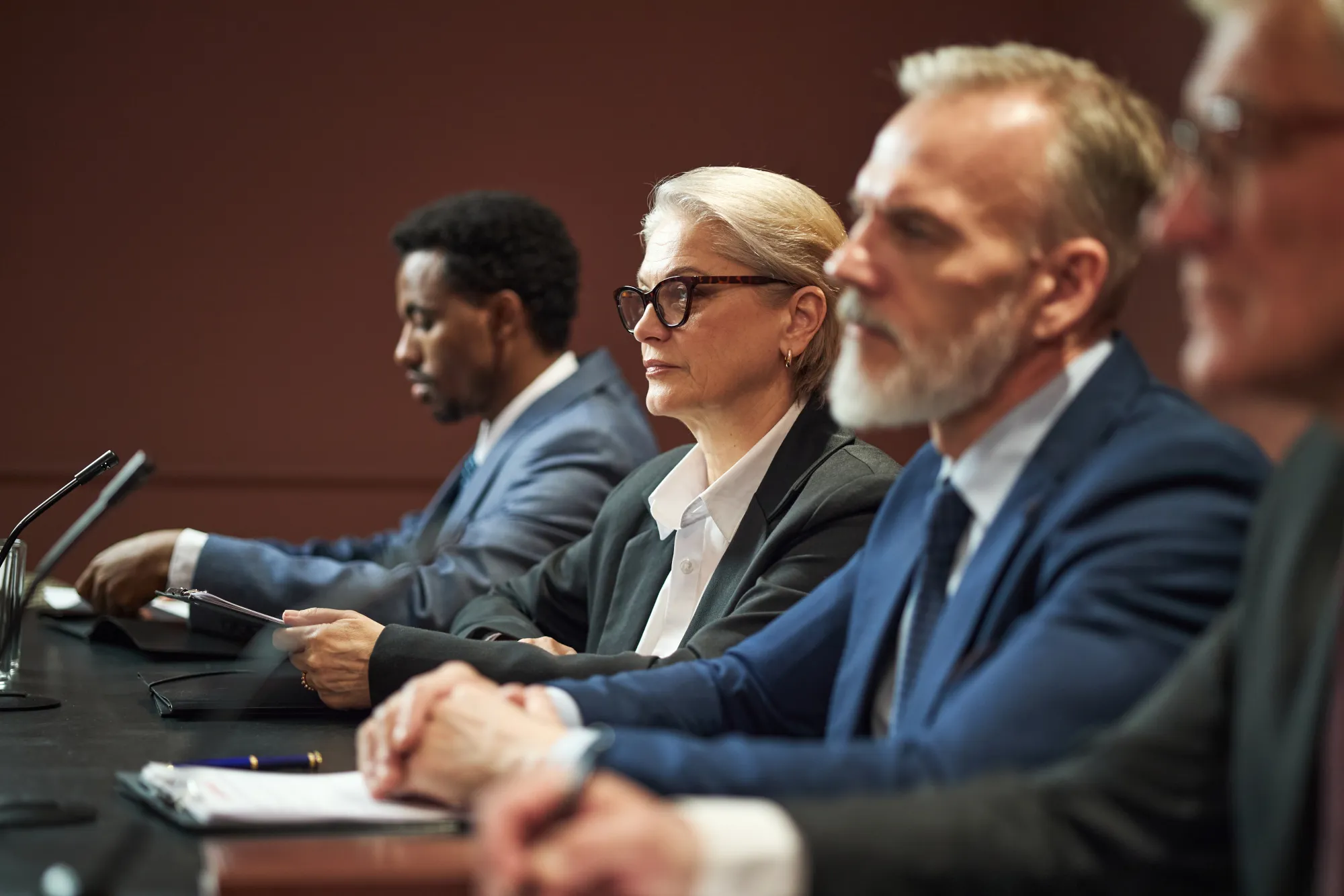 Government officials seated at a committee hearing table
