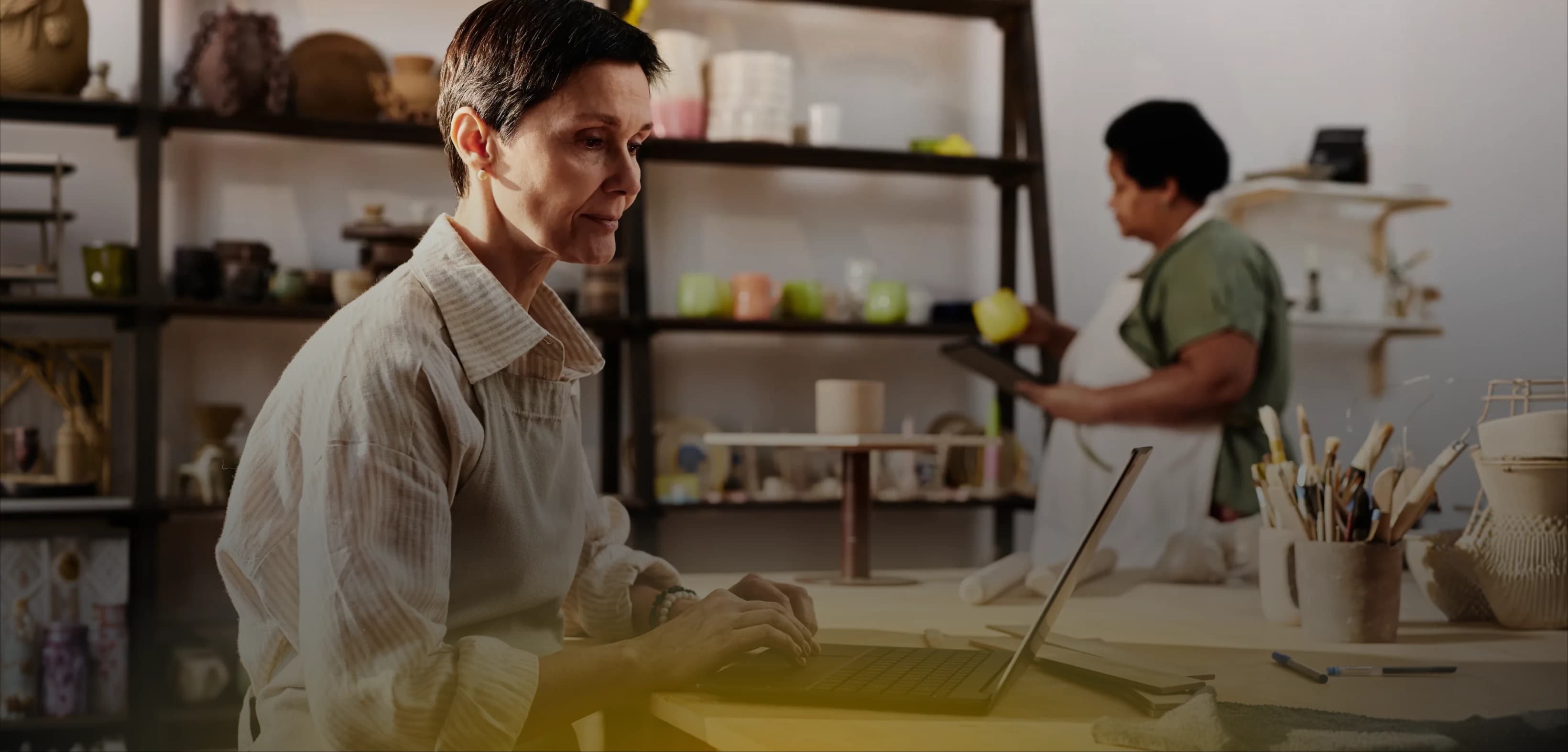 Small-business owner working on a laptop in their shop